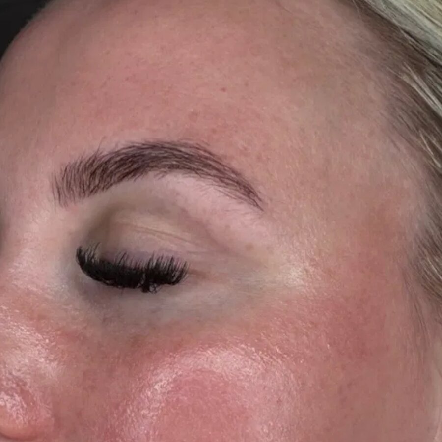Brow shaping and tint with lash extensions in profile