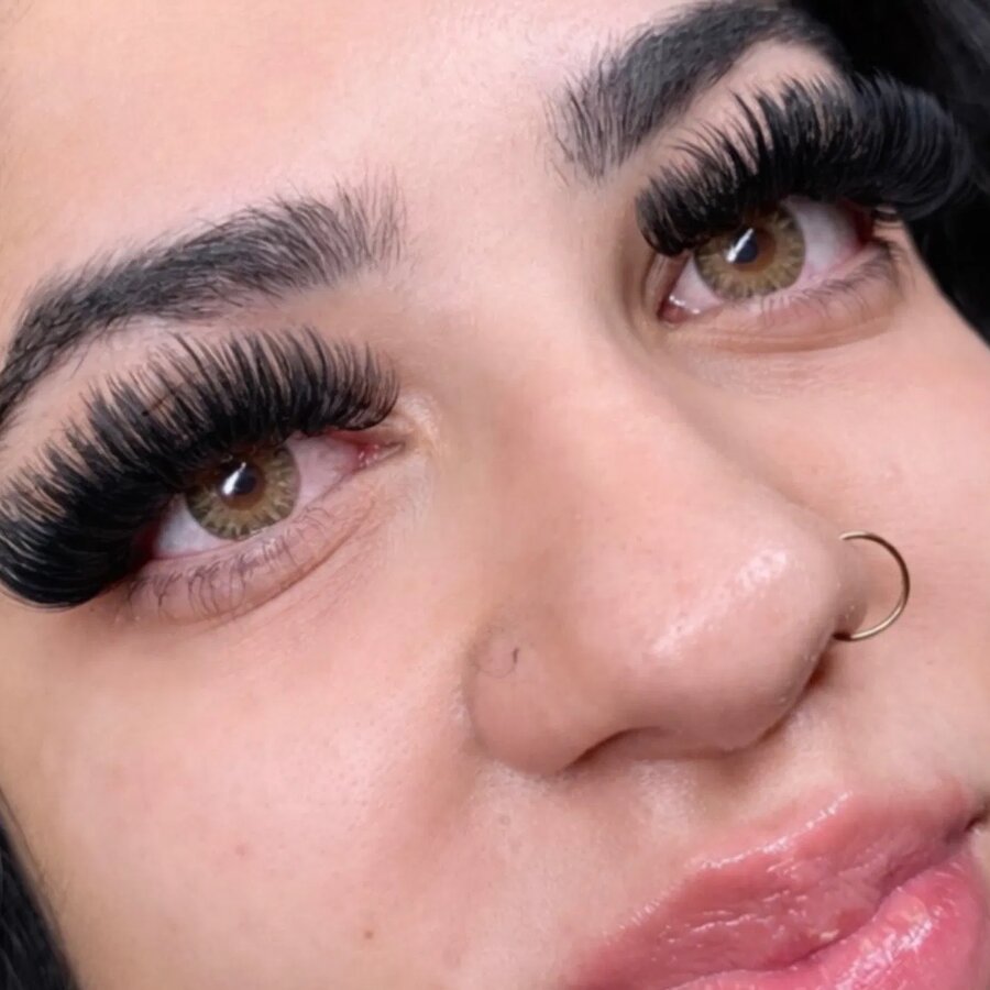 Hybrid lash extensions on a client with both eyes visible